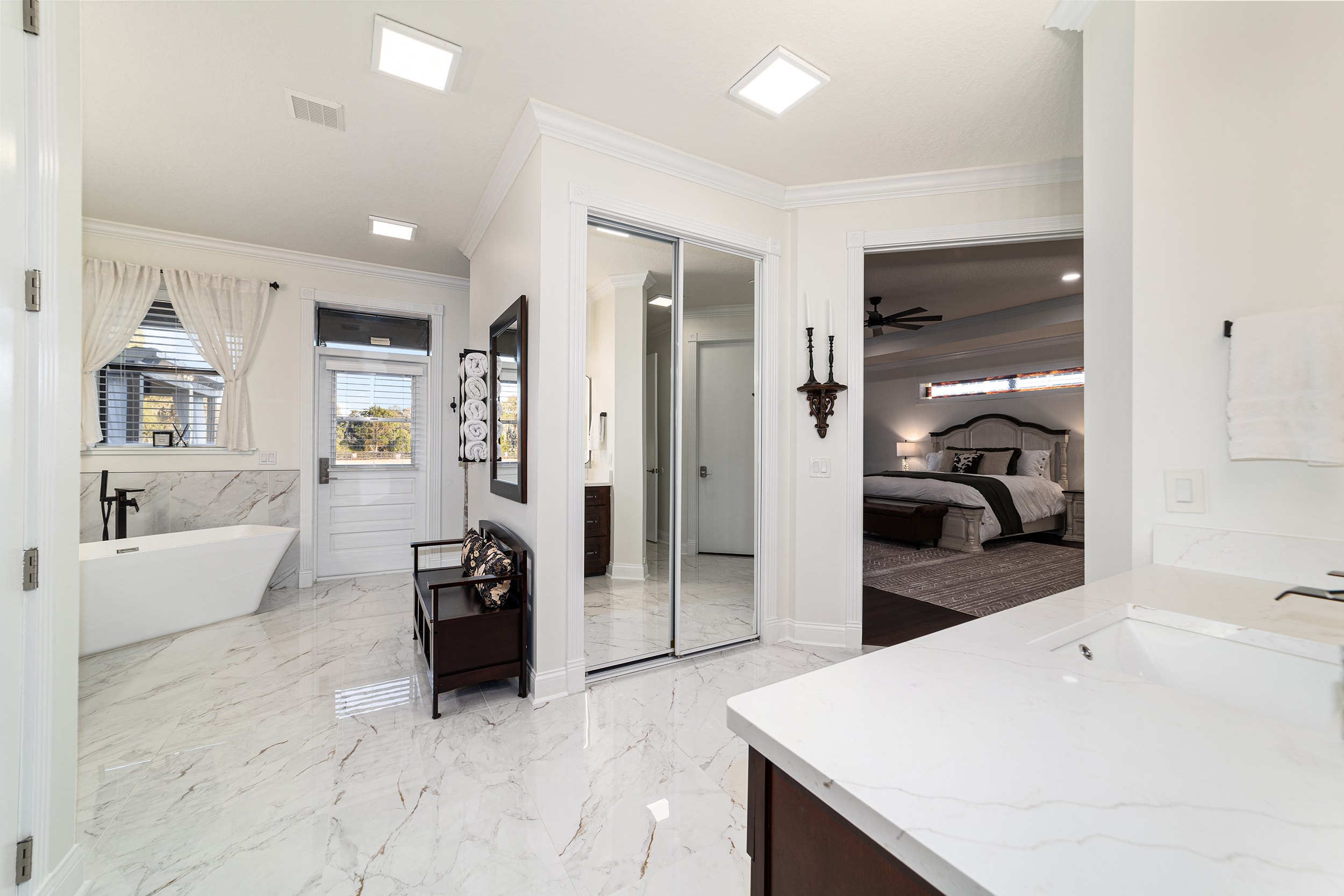 Luxury master bath with marble floors and freestanding soaking tub