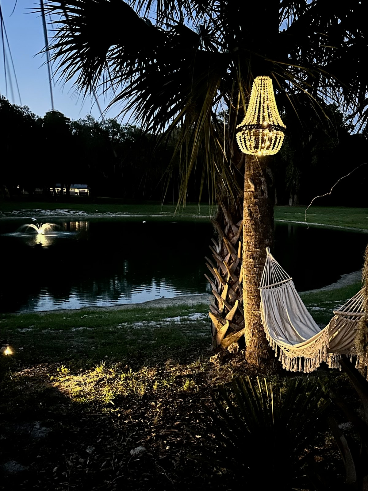 Hammock and crystal chandelier at night with lake reflection at The Ranch