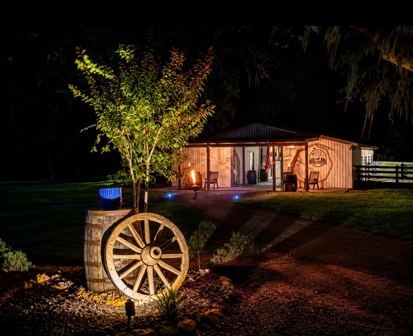 Wagon wheel and wine barrel at The Ranch at night