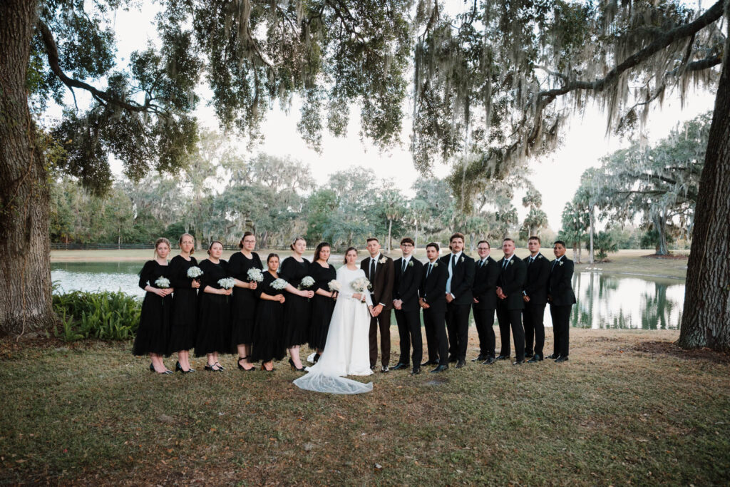Wedding party portrait under oak trees with Spanish moss